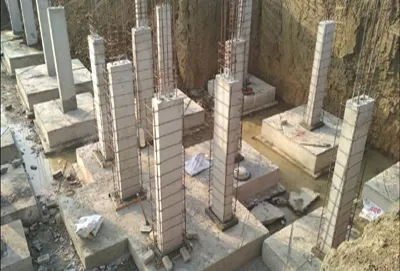 Reinforced concrete columns being erected as part of a foundation construction service.