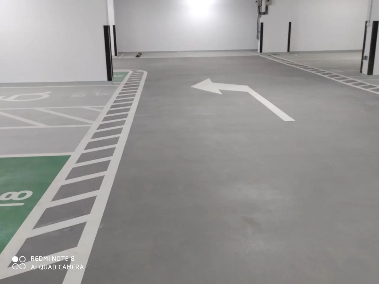 Epoxy floor coating for garage with designated parking spaces and safety markings